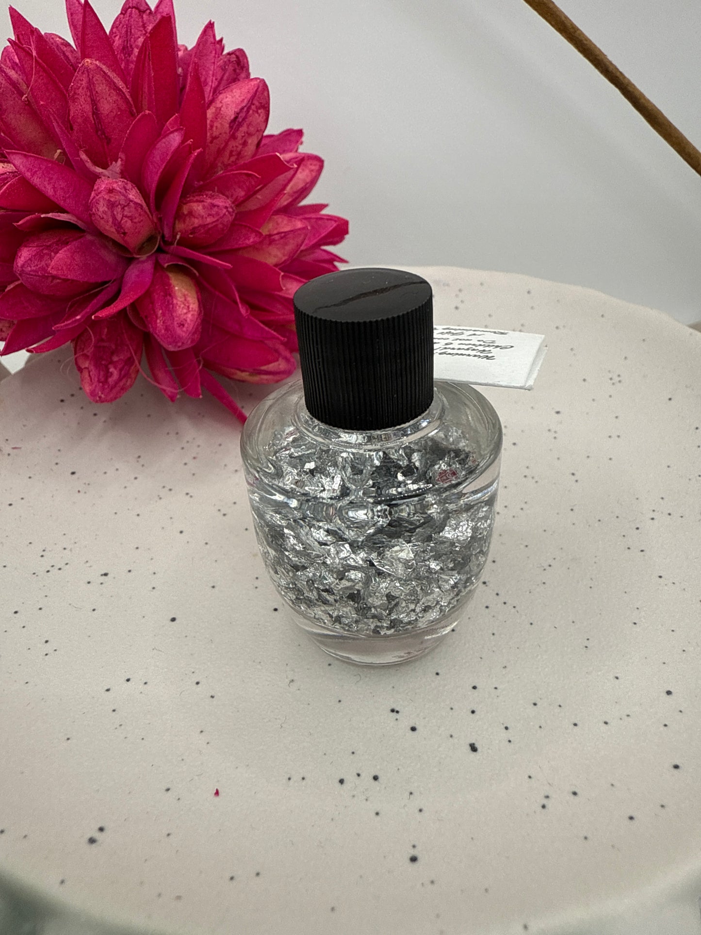 Silver flakes in bottle
